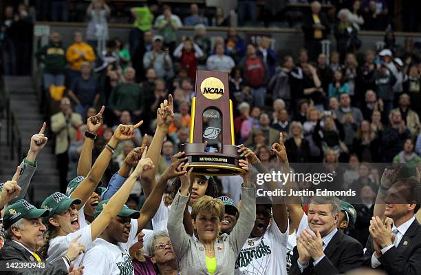 Head coach Kim Mulkey of the Baylor Bears holds up the National Championship trophy as she celebrates with her players after they won 80-61 against...