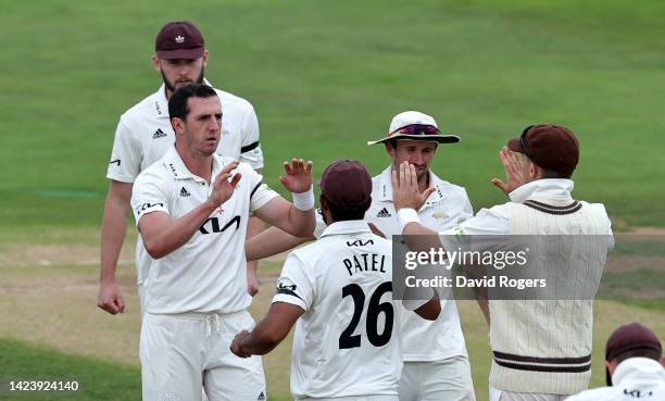 Dan Worrall of Surrey celebrates with team mates after taking the wicket of James Sales during the LV= Insurance County Championship match between...