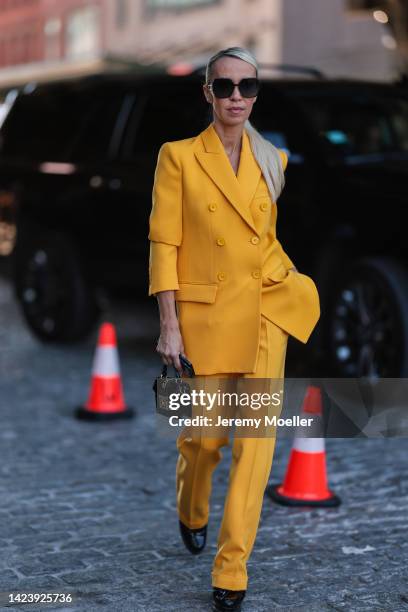 Denisa Palsha is seen wearing black Dior shades, yellow matching Michael Kors suit and black leather mini bag, outside Michael Kors, during New York...