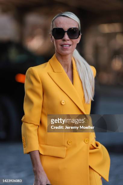 Denisa Palsha is seen wearing black Dior shades, yellow matching Michael Kors suit and black leather mini bag, outside Michael Kors, during New York...