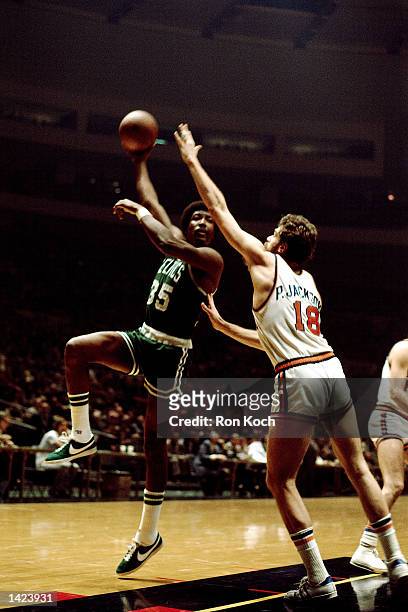 Paul Silas of the Boston Celtics shoots a hookshot against Phil Jackson of the New York Knicks during the NBA game at Madison Square Garden in New...