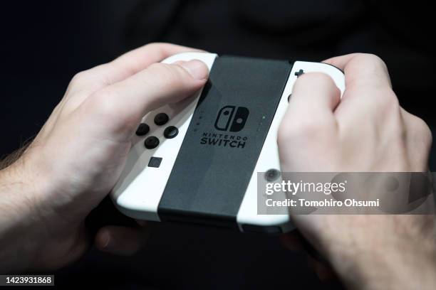 An attendee uses a Nintendo Switch console to play a video game at the Tokyo Game Show 2022 on September 15, 2022 in Chiba, Japan. The event runs for...