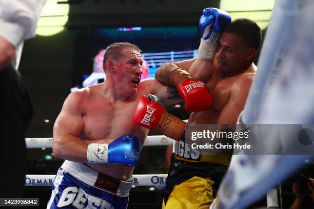 Paul Gallen punches Justin Hodges during their bout at Nissan Arena on September 15, 2022 in Brisbane, Australia.