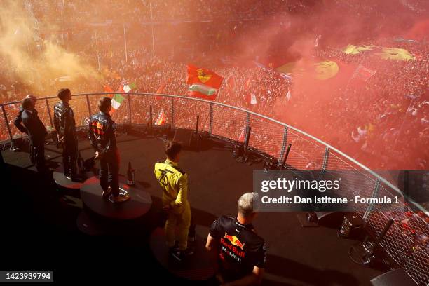 Race winner Max Verstappen of the Netherlands and Oracle Red Bull Racing celebrates on the podium next to second placed Charles Leclerc of Monaco and...