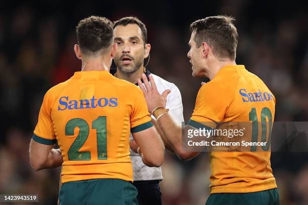 Referee Mathieu Raynal speaks to Nic White and Bernard Foley of the Wallabies during The Rugby Championship & Bledisloe Cup match between the...