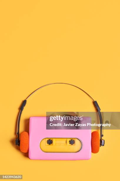 pink portable audio cassette player on yellow background - vintage record player no people stock-fotos und bilder