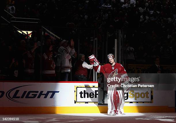 Goaltender Mike Smith of the Phoenix Coyotes waves to the crowd after a 54 save shutout and being named the number one star of the NHL game against...