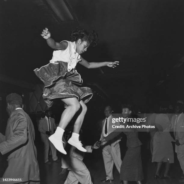 Woman in mid-air during a 'Lindy Hop' dance at the Savoy Ballroom in Harlem, New York City, New York, United States, circa 1947.