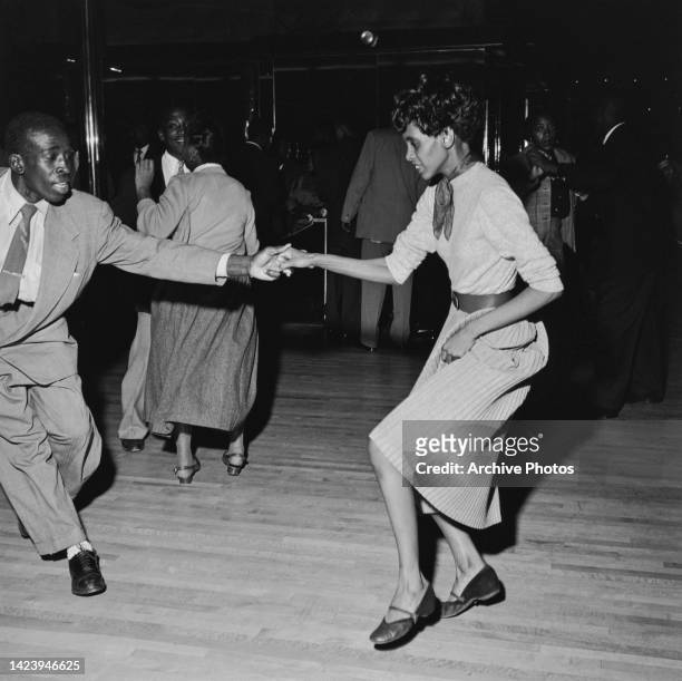 Black Americans take to the dancefloor to show off their 'Swing' dance moves at the Savoy Ballroom in Harlem, New York City, New York, United States,...