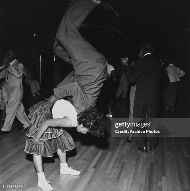 Woman and man perform the Lindy Hop dance at the Savoy Ballroom in Harlem, New York City, New York, United States, circa 1947.