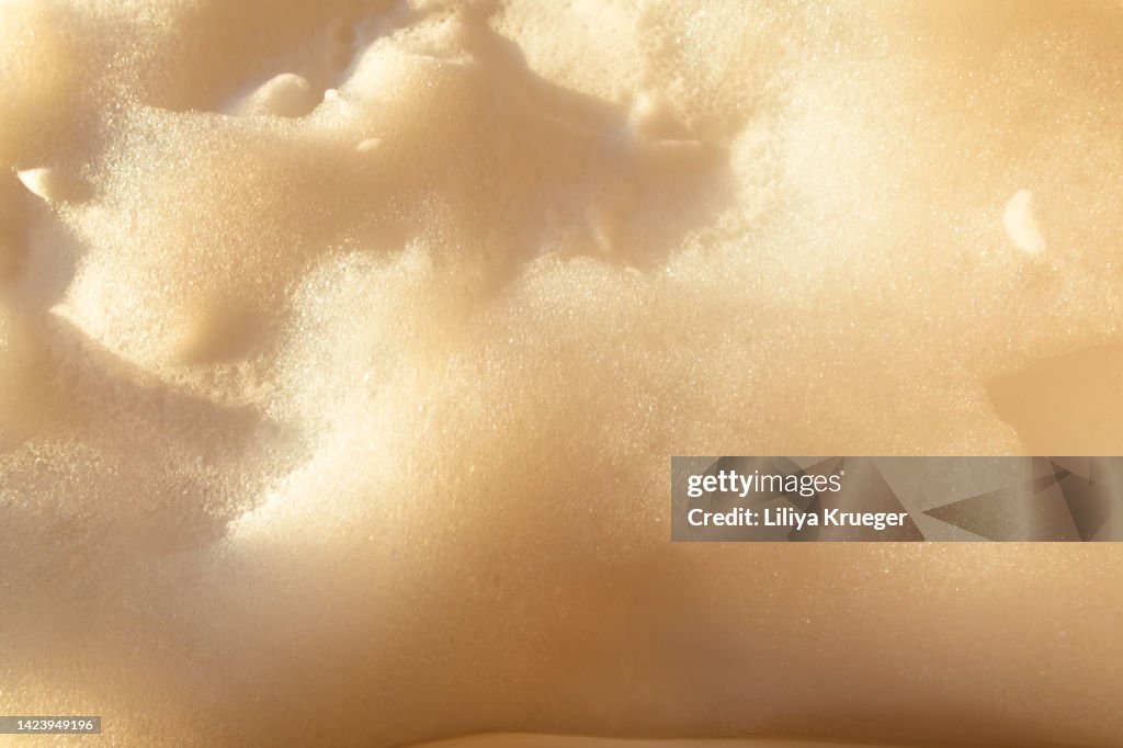 Abstract background with foam in sunset light.