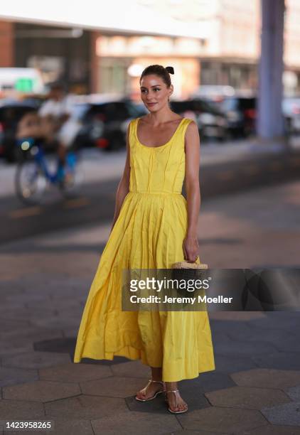 Olivia Palermo is seen wearing a yellow Jason Wu long dress, beige raffia bast bag, and gold leather sandals, outside Jason Wu show, during New York...