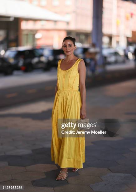 Olivia Palermo is seen wearing a yellow Jason Wu long dress, beige raffia bast bag, and gold leather sandals, outside Jason Wu show, during New York...