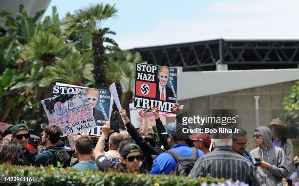Protestors of US Republican Presidential candidate Donald Trump display signs outside the Anaheim Convention Center as Presidential candidate Trump...