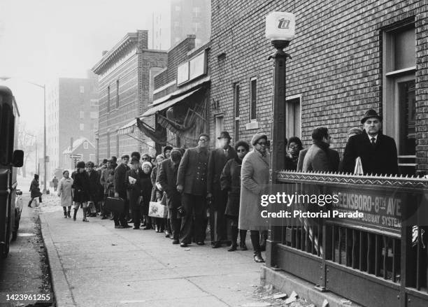 People waiting in line for their new subway tokens, on the first morning of a 50% fare increase , queuing at the entrance to an Independent Subway...