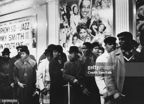 An unspecified group of Black people waiting in at the Apollo Theater in Harlem neighbourhood of Manhattan, New York City, New York, circa 1960. The...