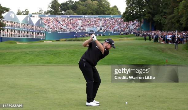 Shane Lowry of Ireland plays his second shot into the 18th green during Day Four of the BMW PGA Championship at Wentworth Golf Club on September 11,...