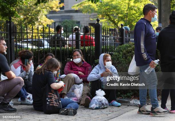 Migrants from Central and South America wait near the residence of US Vice President Kamala Harris after being dropped off on September 15, 2022 in...