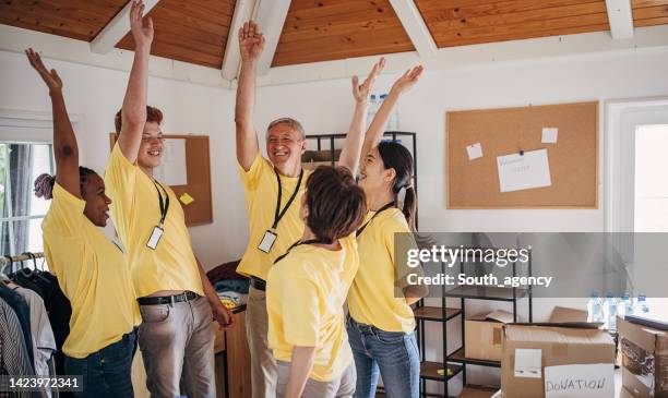 unity among charity volunteers - spirit of volunteerism stock pictures, royalty-free photos & images