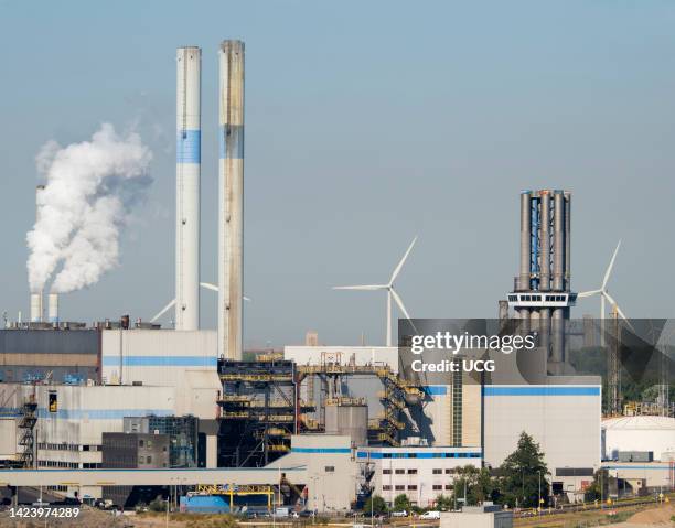 Wind turbines, power station and mixed industrial plant in the Maas Estuary, approaching Rotterdam Container Port, the Netherlands.