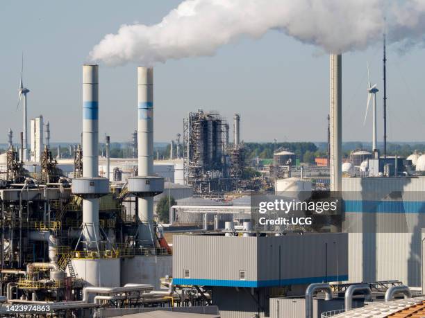 Wind turbines, power station and mixed industrial plant in the Maas Estuary, approaching Rotterdam Container Port, the Netherlands.