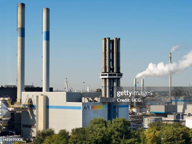 Wind turbines, power station and mixed industrial plant in the Maas Estuary, approaching Rotterdam Container Port, the Netherlands.