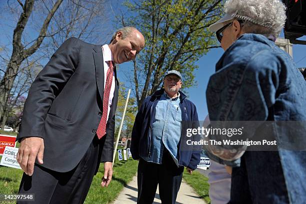 John Delaney, left, who is running for a congressional seat in Maryland's 6th District, greets Jim Lewin, of Frederick, Md., and his wife Carolyn...