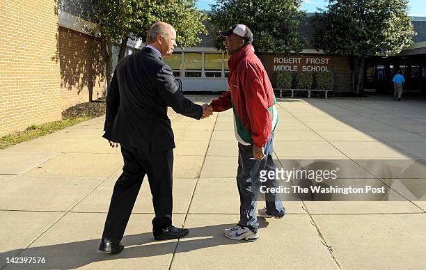 John Delaney, left, who is running for a congressional seat in Maryland's 6th District, greets voter Charles Traylor, of Potomac, Md. At the voting...