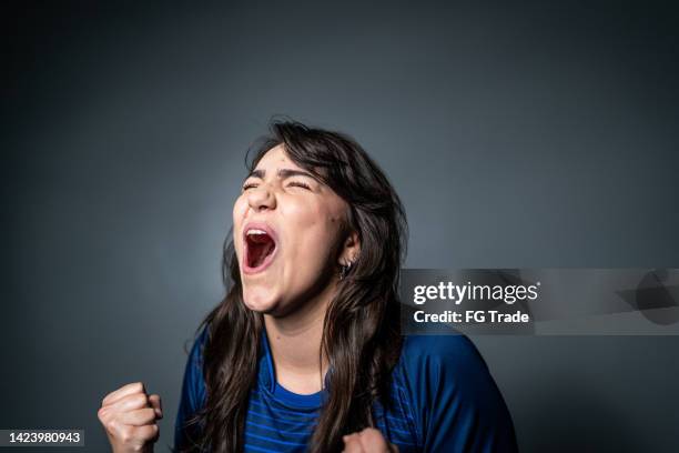 young fan celebrating on blue uniform - ecstatic face stock pictures, royalty-free photos & images