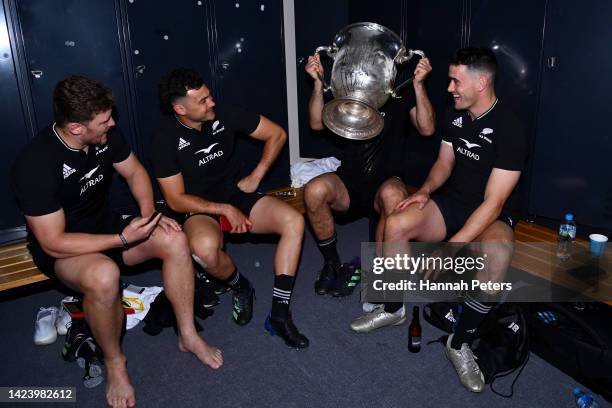 Dalton Papali’i, David Havili, Sam Whitelock and Will Jordan of the All Blacks celebrate with the Bledisloe Cup in the changing room after winning...