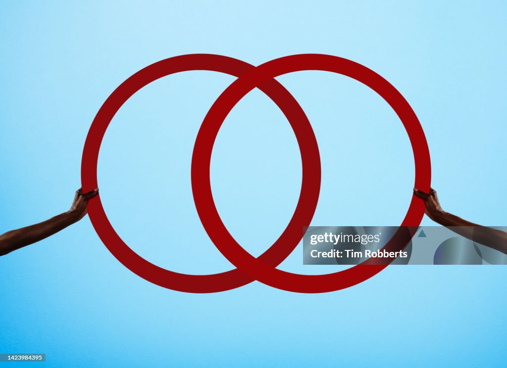 Two arms holding illustrated rings