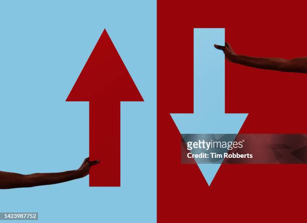 up and down arrow symbol being held - arrow down stock pictures, royalty-free photos & images