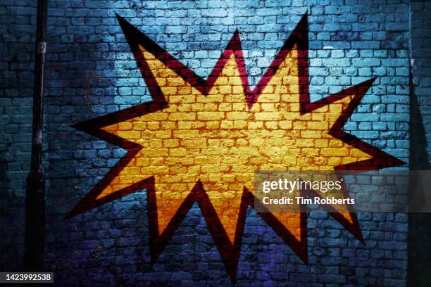 graffiti of explosion on dark wall - unexpected stock pictures, royalty-free photos & images