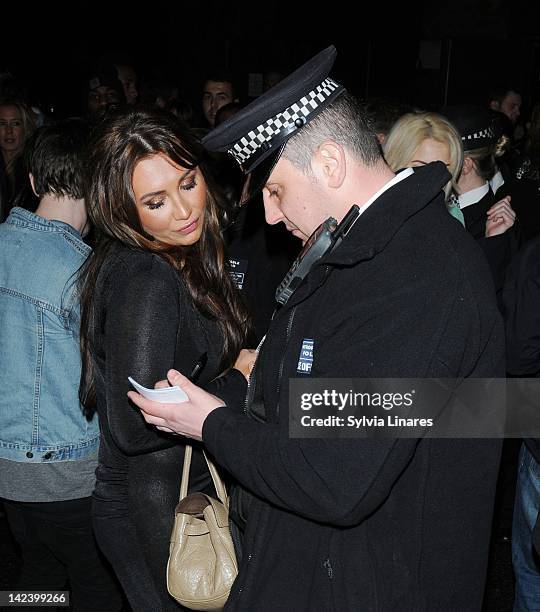 Lauren Goodger gives her details to a police officer as she leaves The Bankside Vaults also known as Pulse on April 3, 2012 in London, England....