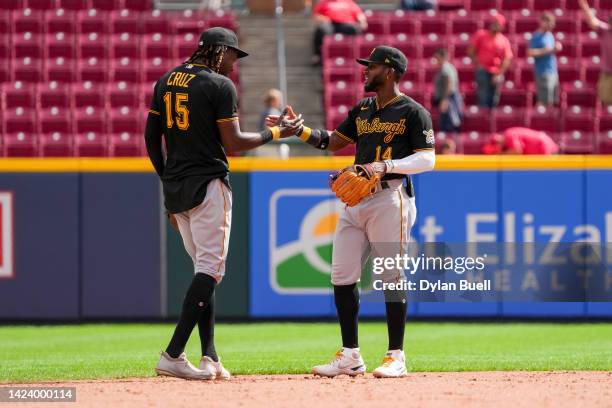 Oneil Cruz and Rodolfo Castro of the Pittsburgh Pirates celebrate after beating the Cincinnati Reds 6-1 in game one of a doubleheader at Great...