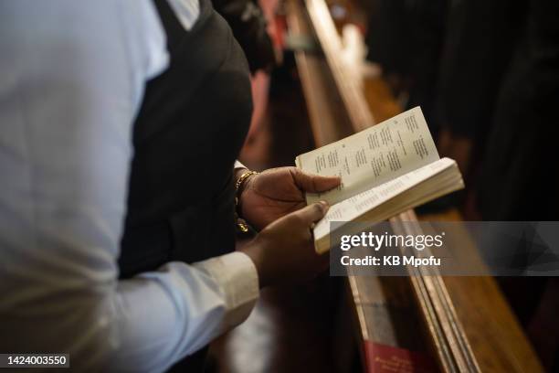 Member of the congregation sings from a hymn book during Queen Elizabeth II memorial service on September 15, 2022 in Harare, Zimbabwe. Queen...