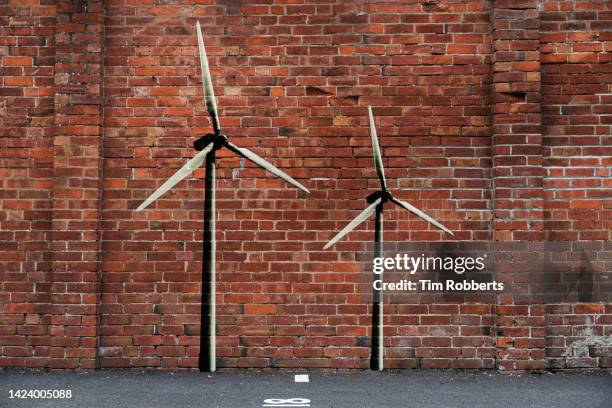 graffiti of wind turbines on brick wall - graffiti on brick wall stock-fotos und bilder