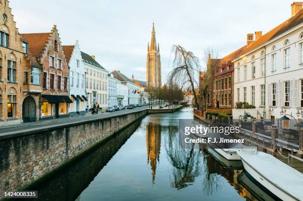 landscape with canals in bruges at sunrise - belgium landscape stock pictures, royalty-free photos & images