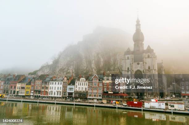 landscape of dinant village in belgium with fog - overcast stockfoto's en -beelden