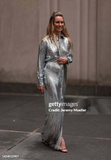 Fashion Week Guest seen wearing a silver shiny pailettes dress and a Bottega Veneta pouch during New York Fashion Week on September 13, 2022 in New...