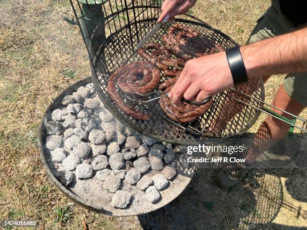 grilling fresh homemade wild game sausage for a south african traditional braai - south african culture stock pictures, royalty-free photos & images