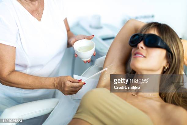 mid adult woman enjoying and relaxing while getting beauty treatments - hairy body woman stock pictures, royalty-free photos & images