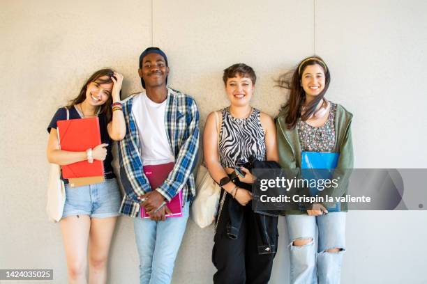 smiling multiracial students standing together on college campus, white  background - 18 years white background stock pictures, royalty-free photos & images