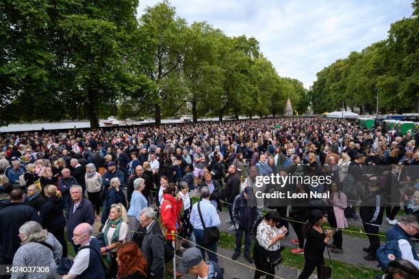 Members of the public wait in a queue to pay their respects to Queen Elizabeth II outside the Houses of Parliament on September 15, 2022 in London,...