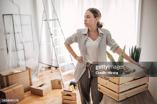 young woman in new home - exhale stock pictures, royalty-free photos & images