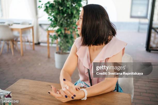 woman at a business dinner in a cafe - woman sleeveless stock pictures, royalty-free photos & images