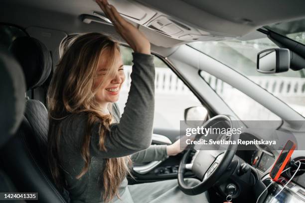 beautiful girl travels by car - förarsäte bildbanksfoton och bilder