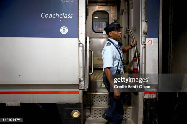 Amtrak conductor Eric Courtney helps to boards passengers for a train to Milwaukee at Union Station on September 15, 2022 in Chicago, Illinois....