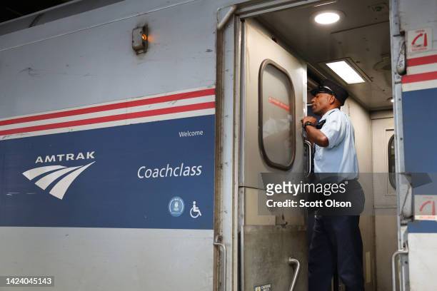 Amtrak conductor Eric Courtney makes announcements to passengers as they board a train to Milwaukee at Union Station on September 15, 2022 in...