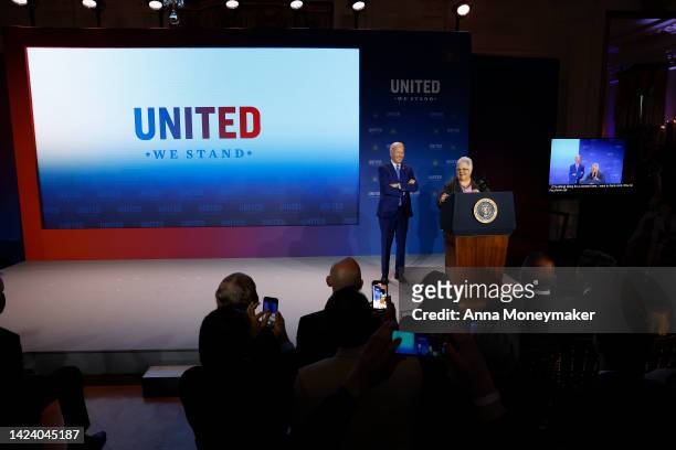 President Joe Biden listens as Susan Bro, mother of Heather Heyer, delivers remarks at the United We Stand Summit in the East Room of the White House...
